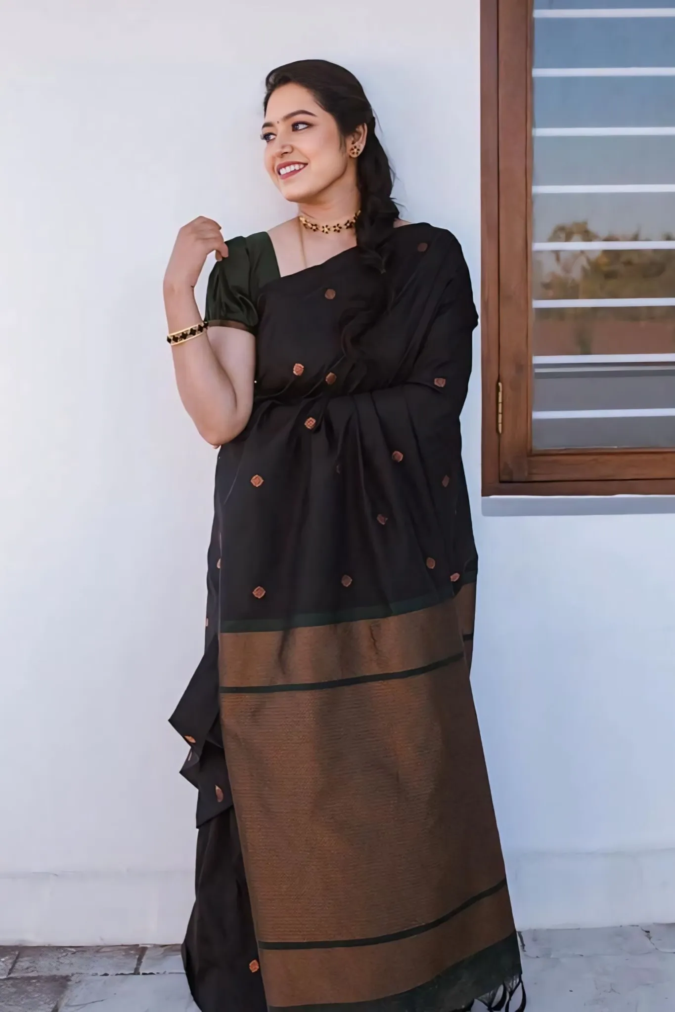 A FOREST SILK SAREE WITH SUBTLE ZARI BUTTAS AND RICH BORDER