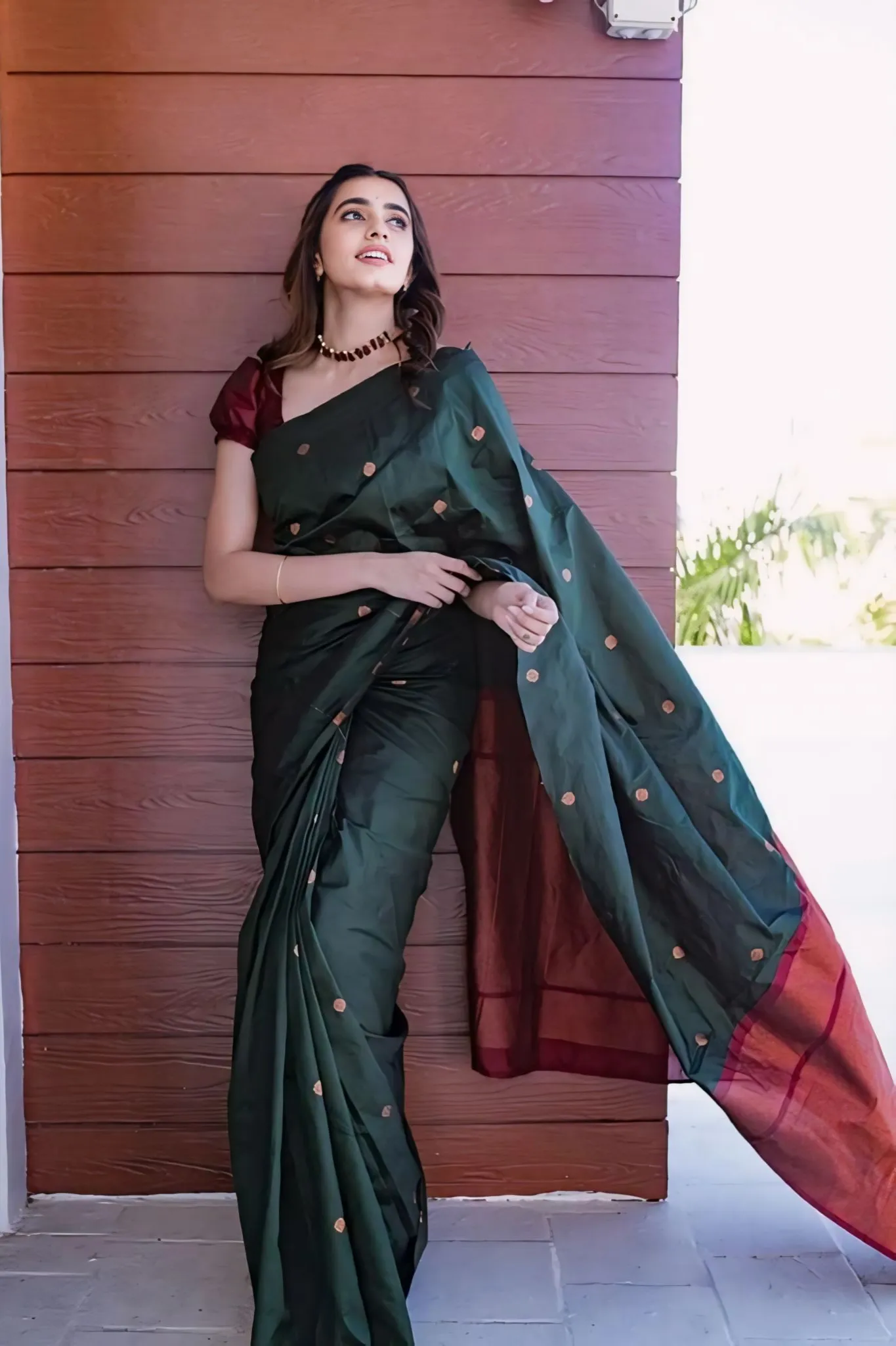 A FOREST SILK SAREE WITH SUBTLE ZARI BUTTAS AND RICH BORDER