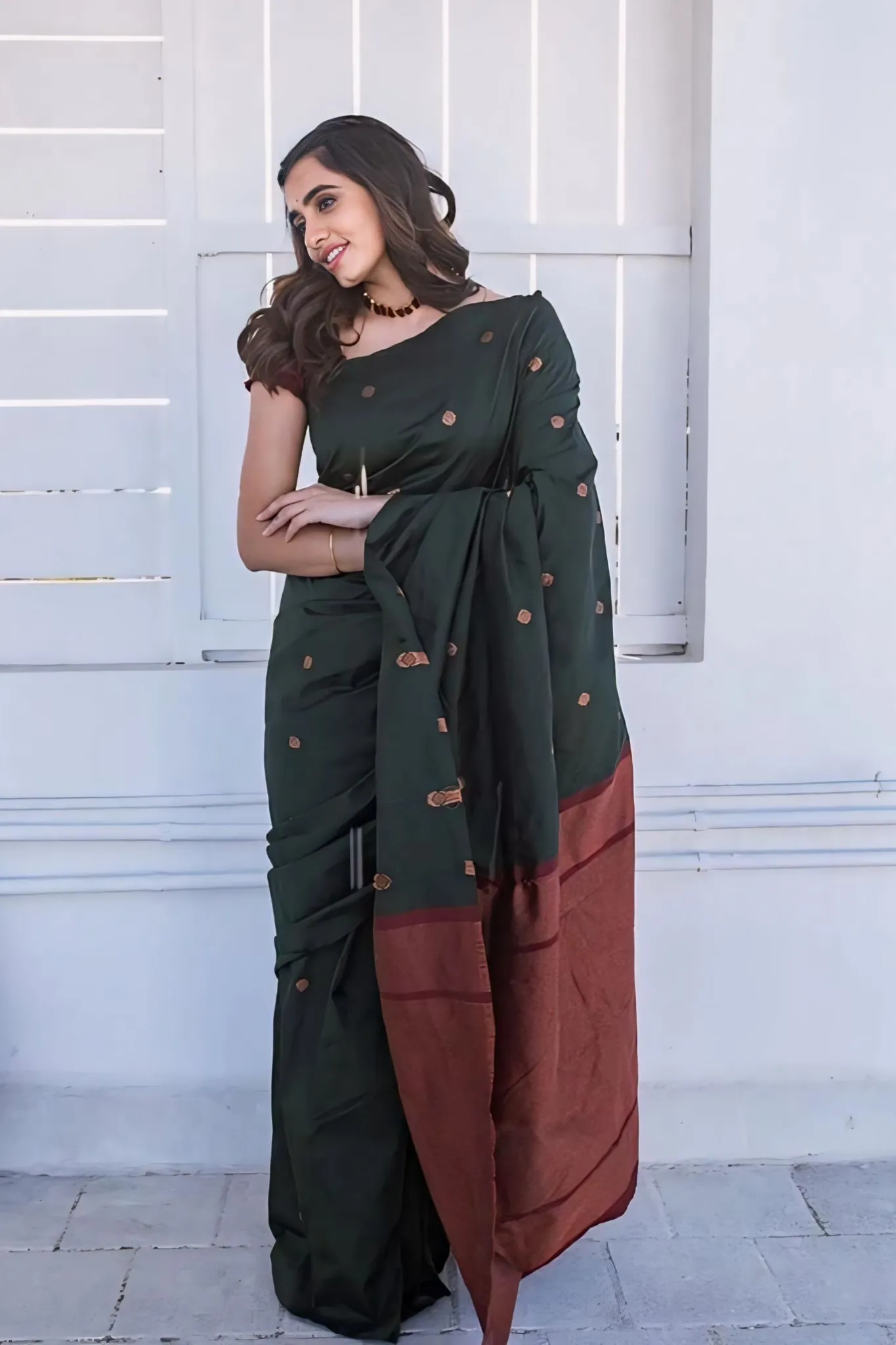A FOREST SILK SAREE WITH SUBTLE ZARI BUTTAS AND RICH BORDER