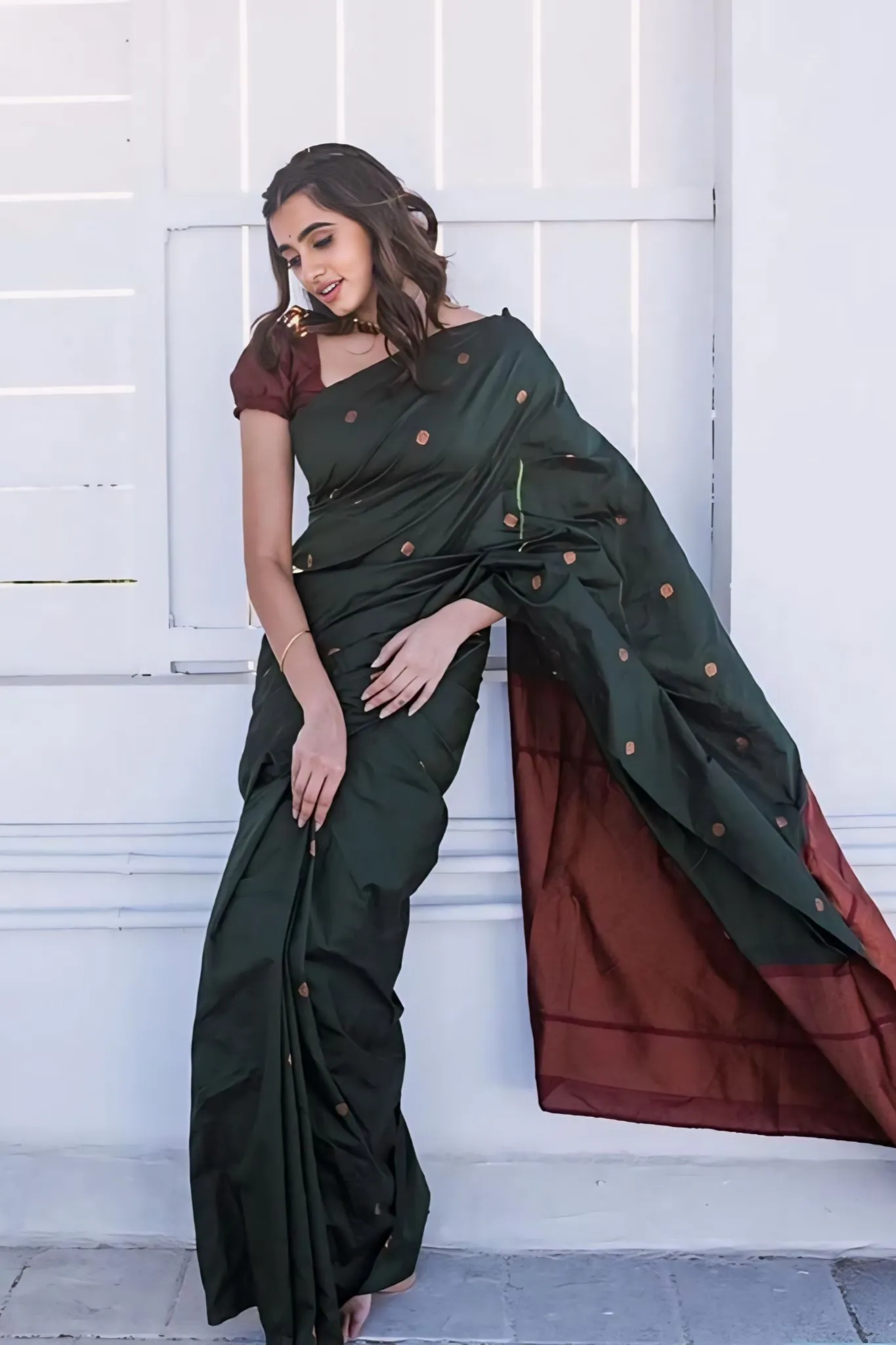 A FOREST SILK SAREE WITH SUBTLE ZARI BUTTAS AND RICH BORDER